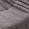 A close-up view of a gray, textured fabric with quilted lines. Produktbild-Vorschau