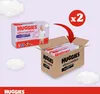 A package of Huggies Ultra Comfort diapers is shown next to a cardboard box containing two more packages, with a red arrow indicating the addition of the two packages to the box. Podgląd zdjęcia produktu