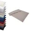 A stack of pillowcases in various colors and a folded duvet cover set in taupe. Produktbild-Vorschau