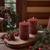 Christmas-themed still life with candles, pine branches, and ornaments. Anteprima dell’immagine prodotto