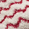 A close-up view of a textured fabric with a zigzag pattern of red and white threads. Produktbild-Vorschau