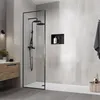 A modern bathroom with a walk-in shower, vanity, and tiled walls. Podgląd zdjęcia produktu