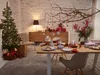 A Christmas-themed dining table setting with a decorated tree and gifts. Produktbild-Vorschau