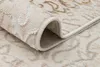 A close-up view of a rolled-up rug, showing the texture and pattern of the fabric. Produktbild-Vorschau