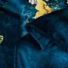 A close-up view of a folded dark teal blanket with a butterfly pattern. Produktbild-Vorschau