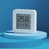 A white Xiaomi MI Monitor 2 sensor is displayed on a blue platform against a blue background. Podgląd zdjęcia produktu