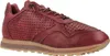A single red leather sneaker is shown from the side against a white background. Voir les images du produit