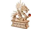A wooden 3D model of a dragon on a decorative base, holding a red orb. Anteprima dell’immagine prodotto