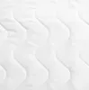 A close-up, abstract view of a white quilted mattress topper. Náhľad obrázku produktu