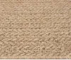 A close-up view of a woven rug with a textured pattern. Produktbild-Vorschau