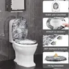 A toilet with a decorative lid and seat in a bathroom setting, with accompanying feature callouts. Produktbild-Vorschau
