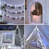 A collage of four images showcasing different ways to use white LED string lights for decoration, including hanging photos, decorating a mirror, creating festive displays with reindeer and Christmas trees, and adorning a teepee. Produktbild-Vorschau