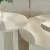Two round coffee tables are placed next to each other in a living room setting, with a sofa in the background and a book on one of the tables. Voir les images du produit