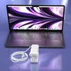 A laptop and its charger are shown on a reflective surface. Podgląd zdjęcia produktu