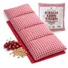 A red and white checkered cherry pit pillow and a bunch of cherries are displayed on a white background. Produktbild-Vorschau