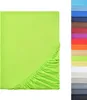 A flat sheet of green fabric with elasticated edges, displayed on a white background. A vertical strip of various colored fabric swatches is visible on the right side of the image. Produktbild-Vorschau