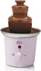 A pink electric chocolate fountain with a brown ceramic top filled with chocolate. Náhľad obrázku produktu