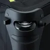 A close-up view of a black travel bag's wheel and corner protector. Voir les images du produit