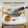 A handheld vacuum cleaner is being used to clean up spilled food on a high chair tray and cushion. Podgląd zdjęcia produktu