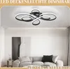 A modern living room with a sofa, artwork, and a stylish LED ceiling light. Produktbild-Vorschau