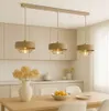A modern kitchen or dining area with a pendant light fixture hanging over a wooden table. Produktbild-Vorschau