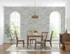 A dining room with a table, chairs, and a stone-patterned wall. Produktbild-Vorschau