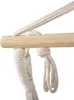 A close-up of a hammock chair's wooden spreader bar with ropes attached. Produktbild-Vorschau