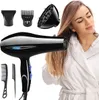 A woman in a white robe is drying her hair with a black hairdryer. Several attachments are displayed around the hairdryer. Produktbild-Vorschau
