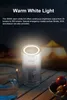 A camping lantern is shown on a wooden table at night, with tents in the background. Produktbild-Vorschau