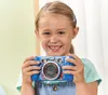A young girl is holding a blue toy camera and smiling at the viewer. Podgląd zdjęcia produktu