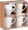 A set of four white ceramic mugs packaged in a cardboard box with a clear plastic window. Podgląd zdjęcia produktu