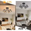 A split image showing a ceiling light fixture in two different room settings, one with a warmer tone and the other with a cooler tone. The left side shows the light in a room with a painting on the wall and a sofa. The right side shows the light in a simil Produktbild-Vorschau