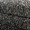 A close-up view of a folded carpet with a textured, mottled black and gray pattern. Produktbild-Vorschau