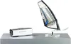 A silver electronic device and a model windsurfing sail are displayed on a silver shelf against a white background. Náhled obrázku produktu
