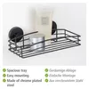 A black wire shower caddy with a bottle of lotion and a jar of cream on it, mounted on a white wall. Produktbild-Vorschau