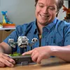A man is interacting with a Lego Pokemon Geodude model on a table. Náhľad obrázku produktu