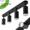 A black ceiling lamp with four adjustable spotlights is shown against a white background. A green overlay with text is in the top left corner. Voir les images du produit