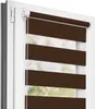 A close-up view of a brown and white striped roller blind installed in a white window frame. Produktbild-Vorschau