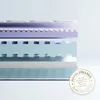 A cross-section of a mattress showing its different layers, with a quality seal on the right. Produktbild-Vorschau