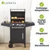 A black gas grill with the lid open, showing food being cooked, placed on a wooden deck with a white wall in the background. Text and checkmarks highlight product features on the right side. Náhled obrázku produktu