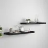 Two black floating shelves mounted on a white wall, decorated with various items. Podgląd zdjęcia produktu