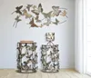 Two decorative side tables with butterfly motifs, a wall decoration of butterflies, and a lamp with a butterfly shade. Produktbild-Vorschau
