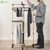 A man is shown interacting with a multi-level drying rack for clothes. Produktbild-Vorschau