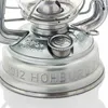 Close-up of the base of a metal lantern, showing embossed text and details. Produktbild-Vorschau
