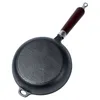 A cast iron frying pan with a wooden handle, shown from the underside. Náhľad obrázku produktu