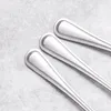 Close-up view of three silver spoons on a textured gray background. Náhled obrázku produktu