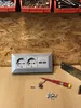 A power strip with USB ports and a screwdriver on a wooden surface. Anteprima dell’immagine prodotto