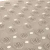 A close-up view of a beige anti-slip bath mat with raised circular bumps and small holes. Voir les images du produit