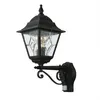 A black outdoor wall lamp with a motion sensor attached to the mounting bracket. Produktbild-Vorschau