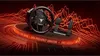 A racing wheel and pedal set displayed on a circular platform with abstract red lines and sound wave graphics in the background. Anteprima dell’immagine prodotto